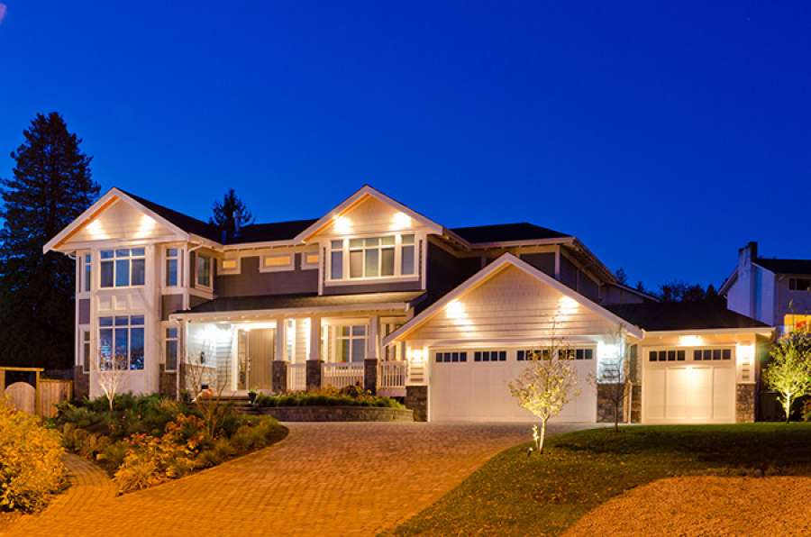 House lit up at night. 